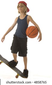 Goofing Around -- Caucasian Boy Of Ten With Long Blond Hair Holds Basketball Under One Arm And Stands Balanced On End Of Skateboard