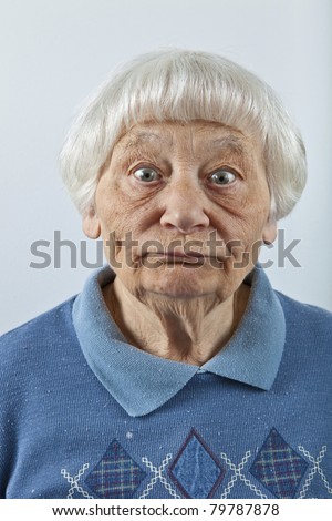 Goofy senior woman head and shoulders portrait