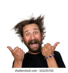 Goofy Young Man Grins At The Camera While Giving A Thumbs Up Sign. Isolated On White Background.