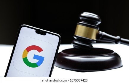 Google Logo Seen On The Smartphone Placed Next To The Judges Gavel. Concept For A Lawsuit, Legal Case, Antitrust And Fine. Real Photo, Not A Montage. Stafford, United Kingdom - December 15 2020: 