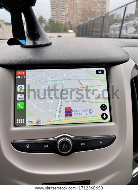 Google Maps on vehicle screen with a red car.\
Also Apple Music, Call icon on the left pane. Navigation with\
controls on car dashboard\
screen.