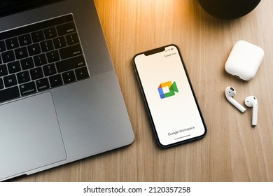 Google Meet App On The Smartphone Screen On Wooden Background. Office Environment. Rio De Janeiro, RJ, Brazil. February 2022.