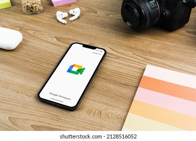 Google Meet App On The Smartphone Screen On Wooden Background. Office Environment. Rio De Janeiro, RJ, Brazil. February 2022.