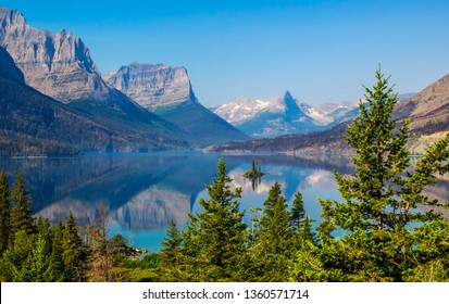 Goose Island in the middle of the St. Mary's  lake with mountains peaks and reflection on background in Glacier National Park, Montana.  - Powered by Shutterstock