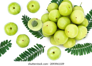 Gooseberry fruit (phyllanthus emblica, amla) with green leaves and half slice isolated on white background. Top view. Flat lay.