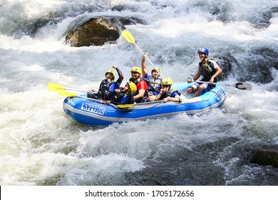 Gopeng, Perak / Malaysia - April 16 2016: A group of extreme sports enthusiast shooting rapids with rubber boat.  Extreme sport and recreation lifestyle concept 