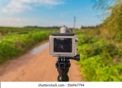 GoPro Action Camera On Stick In Dirt Road At Rural Area