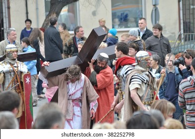 GORA KALWARIA - APRIL 17, 2011: Jesus carrying his cross, on the way to his crucifixion, during the street performances Mystery of the Passion.