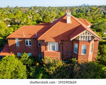 Gordon, Sydney, NSW, Australia - Dec 9 2020: Aerial Shot Of The Side Of A Stately Old Multi Level Home In Afternoon Sunlight, Bay Window And Garden In Leafy Suburb