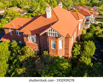 Gordon, Sydney, NSW, Australia - Dec 9 2020: Aerial Shot Of The A Stately Old Multi Level Home In Afternoon Sunlight, Bay Window And Garden In Leafy Suburb