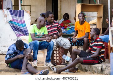 GOREE/SENEGAL - NOVEMBER 11, 2013: A group of senegalese male teenagers sitting and chatting at Goree island, Dakar, Senegal