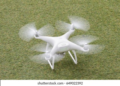GOREME, NEVSEHIR - APRIL 22, 2017: DJI Phantom 4 pro quadcopter drone with a camera on green grass background.