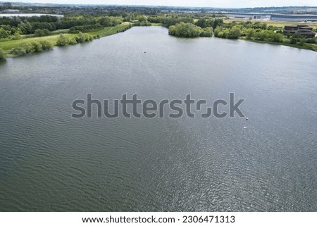 Gorgeous Aerial View of Caldecotte Lake of Milton Keynes City of England Great Britain During Dramatic Clouds over City and Warm Day. The Footage Was Captured on 21-May-2023 with Drone's Camera.