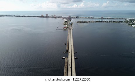 A Gorgeous Aerial View Of Pensacola Beach With The Connecting Gulf Breeze Bridge In Frame. It Looks Like The Letter T From This Distance!