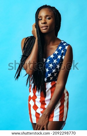 gorgeous african american model in united states flag dress on blue background