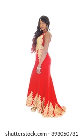 A Gorgeous African American Woman Standing In A Long Red Evening Dress
With Gold Embroideries And Long Black Hair Isolated For White Background.
