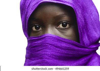 Gorgeous African Girl Hidden by a Violet Head Scarf Outdoors (Isolated on White)