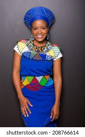 gorgeous african zulu woman standing against black wall
