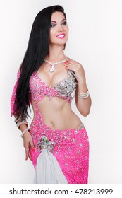 Gorgeous Arabian bellydancer sexy woman in bellydance colorful costume Over white background. Sensual arabic girl belly dancer dancing in studio.