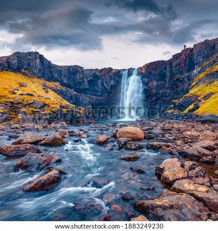 Gorgeous autumn view of Gufufoss (Gufu Waterfall). Astonishing midnight sun scene of typical volcanic landscape of Iceland, Europe. Beauty of nature concept background.