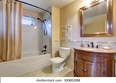 Gorgeous Bathroom With Tan Shower Curtain, And Gold Framed Mirror.