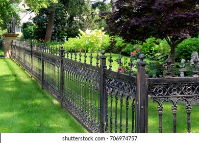 Gorgeous Black Wrought Iron Fencing Marking The Property Lines Of Home And Gardens.