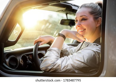 Gorgeous Blonde Female Traveler Driving Through Nature On Cross Country Road Trip, Enjoying The View, Smiling, Conceptual Freedom 