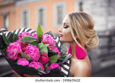 A Gorgeous Blonde Girl In A Couture Fashion Dress With Pink Peonies And Black And White Stripes With A Bouquet Of Bright Pink Flowers.