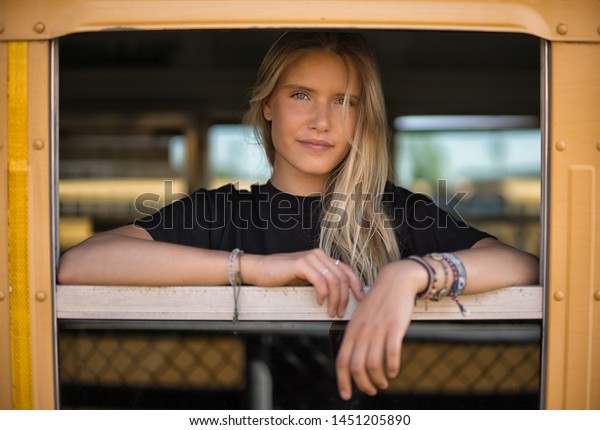 The gorgeous blonde\
in the old bus window