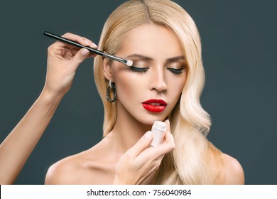 Gorgeous Blonde Woman Applying Makeup, Isolated On Grey