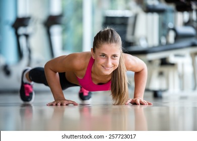 Gorgeous Blonde Woman Warming Up And Doing Some Push Ups A The Gym