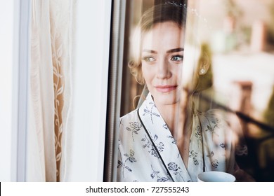 Gorgeous Bride In Elegant Robe Drinking Coffee In Luxury Hotel Room Face Closeup Of Dreamy Expression, Morning Before The Wedding Preparation, Window Reflection