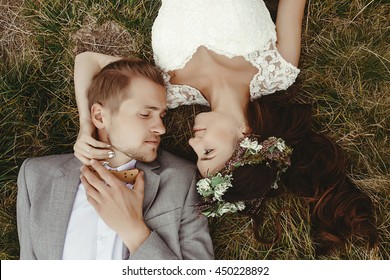 Gorgeous Bride And Stylish Groom Lying On Top, Close Up, Boho Wedding Couple, Luxury Ceremony At Mountains