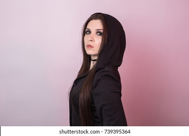 Gorgeous brunette with dark makeup. Halloween witch in studio