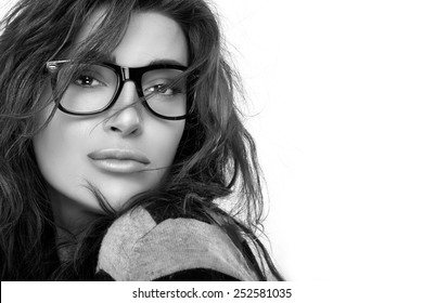Gorgeous Brunette Fashion Model Girl With Casual Hairstyle Wearing Trendy Glasses. Cool Trendy Eyewear Portrait. Closeup In Black And White With Copy Space For Text