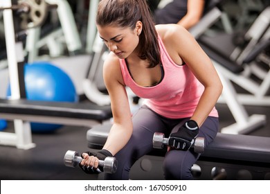 Gorgeous Brunette Lifting Some Weights And Working On Her Biceps In A Gym