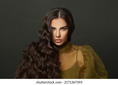 Gorgeous brunette model beauty portrait. Healthy woman with shiny dark wavy hair closeup on black studio wall background