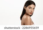 Gorgeous brunette woman with blue eyes, clear glowing skin, perfect shiny body after spa effect, doing nourishing skincare routine, spa at home, standing over white background.