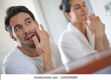   Gorgeous Couple Going Through Daily Beauty Regime In Bathroom                             