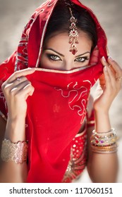 gorgeous eyes of young indian woman in traditional clothing with bridal makeup and jewelry. Beautiful bride traditionally dressed Outdoors in India. Girl bollywood dancer in Sari. Arabian bellydancer