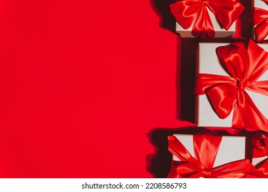 Gorgeous festive Christmas banner or header, holiday presents on red background. Christmas gift boxes on red. Holiday season, New Year. Copy space for text. - Shutterstock ID 2208586793