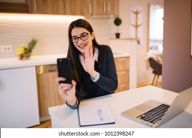 Gorgeous girl video chatting with mobile at home. - Shutterstock ID 1012398247