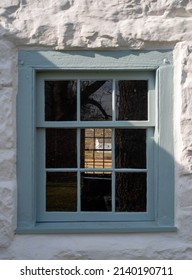 Gorgeous Golden Hour Landscape Viewed Through Two Windows In A Colonial Whitewashed Stone Cottage With Blue Window Frame And Antique Nine-pane And Twelve-pane Glass Windows. No People, With Copy Space