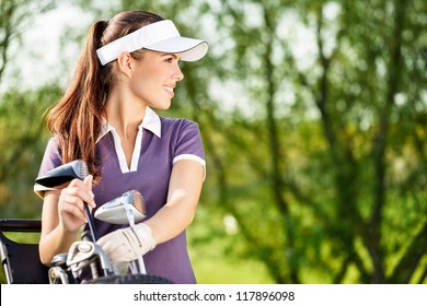 Gorgeous golfer lady with golf equipment