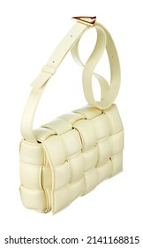 Gorgeous handbag made of braided cream color leather, on a long strap-harness, isolated on a white background. Expensive women's accessories.