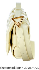 Gorgeous handbag made of braided cream color leather, on a long strap-harness, isolated on a white background. Side view. Expensive women's accessories. High quality photo.