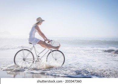 Gorgeous happy blonde on a bike ride at the beach on a sunny day - Powered by Shutterstock