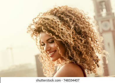 Gorgeous And Happy Woman Portrait With Beautiful Curly Hair Smiling