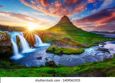 Gorgeous landscape with rising sun on Kirkjufellsfoss waterfall and Kirkjufell mountain, Iceland, Europe. - Powered by Shutterstock