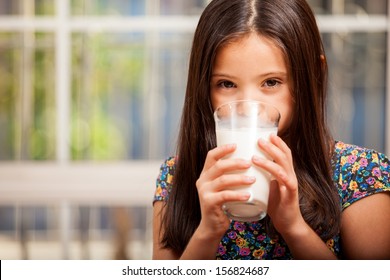 Cô bé tuyệt đẹp uống một ly sữa ở nhà